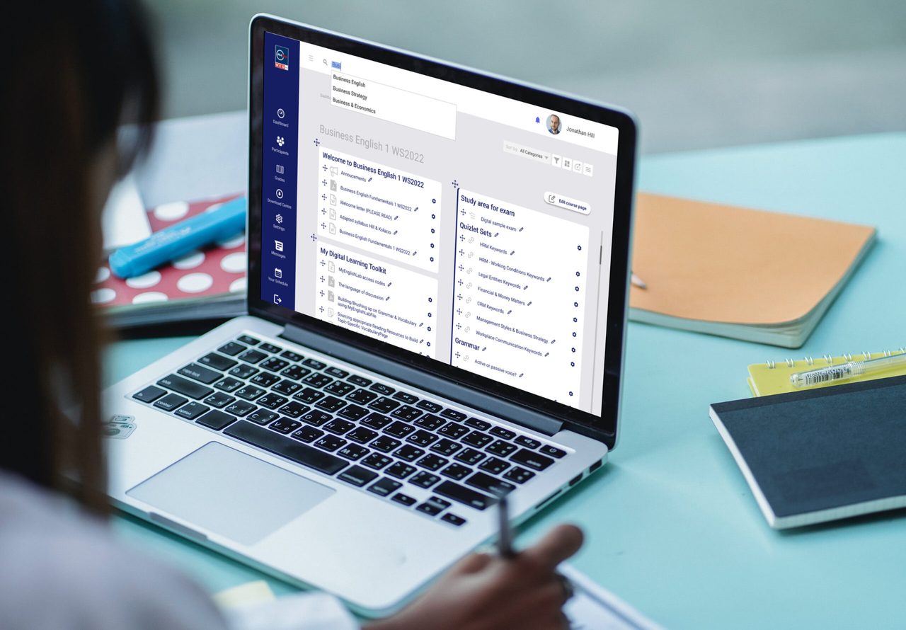 Laptop on a desk showing the university learning platform course dashboard